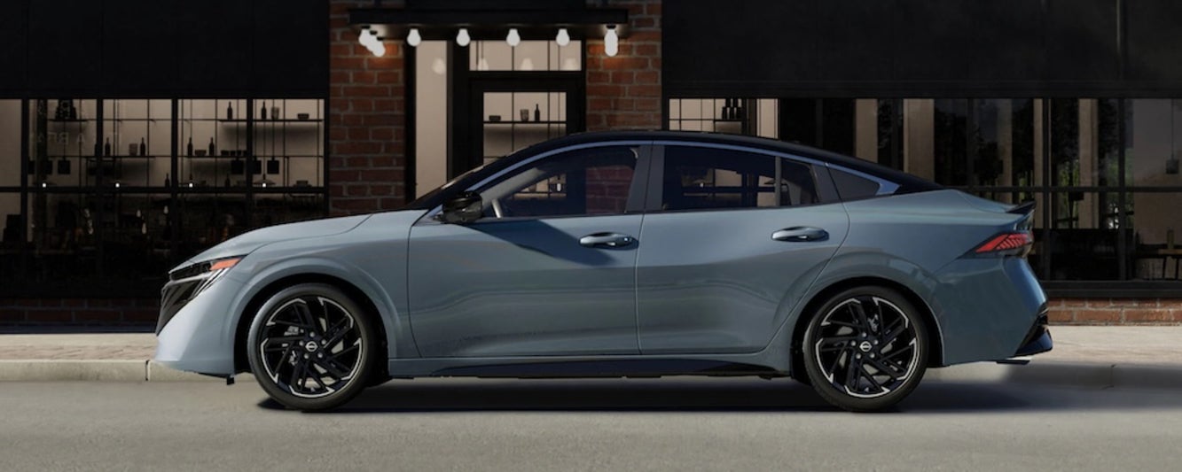 A gray 2026 Nissan Sentra sedan parked in front of a restaurant