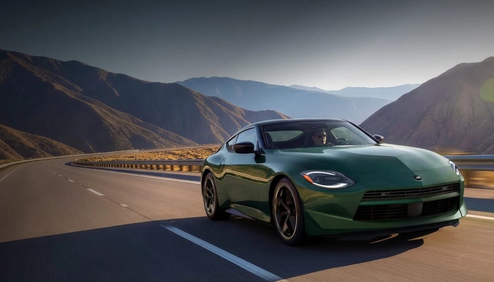 A dark green Nissan Z sports can on a mountain road